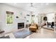 Bright living room featuring a fireplace, a comfortable armchair, and french doors that lead to the dining room at 2217 Brevard Ne Rd, St Petersburg, FL 33704
