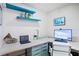 Bright office features a built-in desk with blue floating shelves and ample natural light at 2217 Brevard Ne Rd, St Petersburg, FL 33704