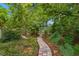 Charming brick path winding through lush greenery and mature trees at 2217 Brevard Ne Rd, St Petersburg, FL 33704