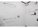 All-white shower featuring subway tile and modern fixtures with recessed shampoo storage niche at 2217 Brevard Ne Rd, St Petersburg, FL 33704