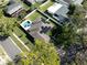 Aerial view of a home with solar panels and a pool at 2648 Countryclub Dr, Clearwater, FL 33761