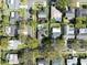 Neighborhood aerial view, showing one house with solar panels and a pool at 2648 Countryclub Dr, Clearwater, FL 33761