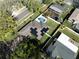 A high angle view shows a fenced yard with pool and a house with solar panels on the roof at 2648 Countryclub Dr, Clearwater, FL 33761