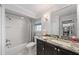 Bathroom with granite countertop, vanity, shower over tub and modern fixtures at 2648 Countryclub Dr, Clearwater, FL 33761