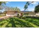 Charming home with a well-manicured lawn, a brick driveway, and solar panels on the roof at 2648 Countryclub Dr, Clearwater, FL 33761