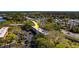 Aerial view of condo, highlighting mature landscaping and proximity to main thoroughfare at 2700 Bayshore Blvd # 1E, Dunedin, FL 34698