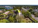 Beautiful aerial view of the property, surrounded by trees and close to a lake and highway at 2700 Bayshore Blvd # 1E, Dunedin, FL 34698