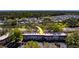 Overhead shot of condo building with parking; surrounded by trees and located along a busy street at 2700 Bayshore Blvd # 1E, Dunedin, FL 34698