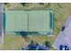 Aerial view of a community tennis court surrounded by green spaces, landscaping, and parking at 2700 Bayshore Blvd # 1E, Dunedin, FL 34698