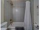 Bathroom with a shower-tub, gold fixtures, and a white shower curtain at 2700 Bayshore Blvd # 1E, Dunedin, FL 34698