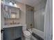 Modern bathroom featuring a gray vanity with marble countertop, sleek tile, and a shower-tub combination at 2700 Bayshore Blvd # 1E, Dunedin, FL 34698