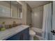 Stylishly remodeled bathroom showcasing a marble vanity and sleek, modern tiling in the shower at 2700 Bayshore Blvd # 1E, Dunedin, FL 34698