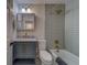 Updated bathroom featuring a gray vanity, shower over tub, and brushed gold fixtures at 2700 Bayshore Blvd # 1E, Dunedin, FL 34698