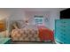 Comfortable bedroom with soft bedding, bright light and turquoise accents and ample natural light at 2700 Bayshore Blvd # 1E, Dunedin, FL 34698