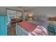 Bright bedroom with a white-framed bed, mirrored closet, and stylish coral accents at 2700 Bayshore Blvd # 1E, Dunedin, FL 34698