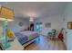 Bright bedroom featuring a four poster bed, wood floors, and a crystal chandelier at 2700 Bayshore Blvd # 1E, Dunedin, FL 34698