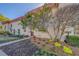 Exterior view of a two-story townhouse with landscaping in front and a brown front door at 2700 Bayshore Blvd # 1E, Dunedin, FL 34698