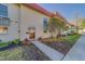 Inviting condo exterior featuring a red tile roof, well-maintained landscaping, and an accessible walkway leading to the front door at 2700 Bayshore Blvd # 1E, Dunedin, FL 34698