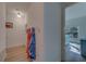 Bright hallway with wood floors, towel rack, and a glimpse into a charming bedroom at 2700 Bayshore Blvd # 1E, Dunedin, FL 34698