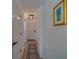 Bright hallway with wood floors, a stylish rug, updated lighting, and fresh white paint at 2700 Bayshore Blvd # 1E, Dunedin, FL 34698