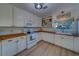 Bright kitchen with white cabinets, butcher block countertops, and modern appliances at 2700 Bayshore Blvd # 1E, Dunedin, FL 34698