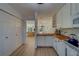 Open concept kitchen with bright white cabinets, butcher block counters, and view to the living area at 2700 Bayshore Blvd # 1E, Dunedin, FL 34698