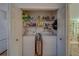 Convenient laundry closet with side-by-side machines, shelving, and easy access to the kitchen at 2700 Bayshore Blvd # 1E, Dunedin, FL 34698