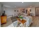 Inviting living room with hardwood floors, comfortable seating, and dining area in background at 2700 Bayshore Blvd # 1E, Dunedin, FL 34698