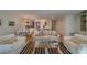 Inviting living room featuring comfortable furniture, a striped rug, and ample natural light at 2700 Bayshore Blvd # 1E, Dunedin, FL 34698