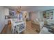 Open-concept living and dining area with stylish furnishings and seamless kitchen access at 2700 Bayshore Blvd # 1E, Dunedin, FL 34698
