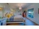 Elegant main bedroom features a four-poster bed, chandelier, and bright natural light at 2700 Bayshore Blvd # 1E, Dunedin, FL 34698