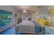 Inviting main bedroom features a four-poster bed, chandelier, and bright natural light at 2700 Bayshore Blvd # 1E, Dunedin, FL 34698