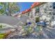 Charming patio features a glass table, four chairs, and a quaint cushioned bench, ideal for outdoor relaxation at 2700 Bayshore Blvd # 1E, Dunedin, FL 34698