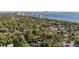 Property aerial showcases the home nestled among trees with city and water views at 2931 W Coachman Ave, Tampa, FL 33611