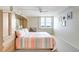 Bright bedroom with a water view, neutral carpet, built-in headboard, and ample natural light for a relaxing ambiance at 400 Island Way # 1708, Clearwater Beach, FL 33767