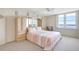 Cozy bedroom featuring water view, neutral carpet, ceiling fan, and unique built-in headboard with storage at 400 Island Way # 1708, Clearwater Beach, FL 33767