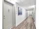 Bright condo hallway leading to unit 1708 with a modern aesthetic and wood-look flooring at 400 Island Way # 1708, Clearwater Beach, FL 33767