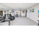 Spacious living room featuring neutral carpet, a mirrored wall, and adjacent dining area for seamless entertaining at 400 Island Way # 1708, Clearwater Beach, FL 33767