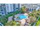 Aerial view of a community pool with lounge chairs and tropical landscaping at 400 Island Way # 1708, Clearwater Beach, FL 33767