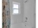 Bright bathroom featuring a bathtub with tiled walls and a shower curtain at 4500 23Rd S Ave, St Petersburg, FL 33711