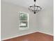 Bright bedroom featuring hardwood floors, a modern chandelier, and a window view at 4500 23Rd S Ave, St Petersburg, FL 33711