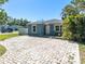 Charming exterior with brick driveway, blue paint, and beautiful landscaping at 4500 23Rd S Ave, St Petersburg, FL 33711