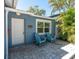 Charming home entrance with blue Adirondack chairs and brick paver patio at 4500 23Rd S Ave, St Petersburg, FL 33711