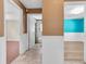 Hallway view showcasing a bathroom and a room with a bright teal wall at 4500 23Rd S Ave, St Petersburg, FL 33711