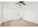 Bright bedroom with a ceiling fan, wood floor, and closet at 5108 Tangelo Dr, New Port Richey, FL 34652
