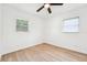 Bright bedroom featuring wood floor and two windows at 5108 Tangelo Dr, New Port Richey, FL 34652