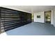 Covered carport with painted floor and black metal privacy screen at 5108 Tangelo Dr, New Port Richey, FL 34652