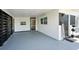 Covered carport featuring a welcome sign and painted floor at 5108 Tangelo Dr, New Port Richey, FL 34652