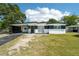 Charming single-story home featuring a stylish carport and a well-maintained front lawn under a bright, sunny sky at 5108 Tangelo Dr, New Port Richey, FL 34652