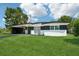 Beautiful single-story home with well-maintained lawn and modern black and white paint at 5108 Tangelo Dr, New Port Richey, FL 34652